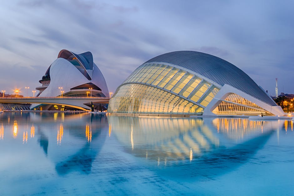 A breathtaking view of Valencia's City of Arts and Sciences reflected in serene waters at twilight