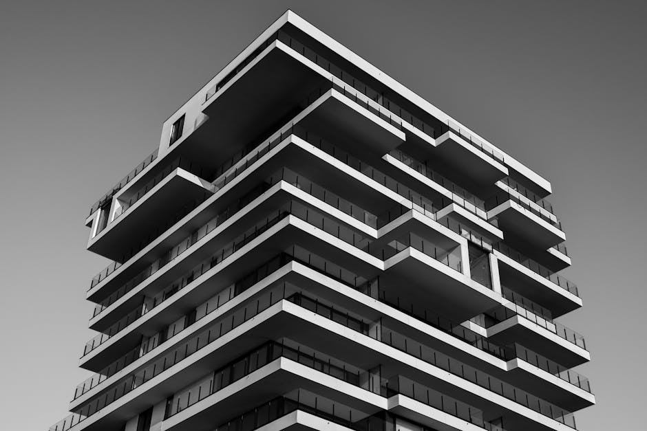 A striking black and white photo of a modern high-rise building with unique geometric designs
