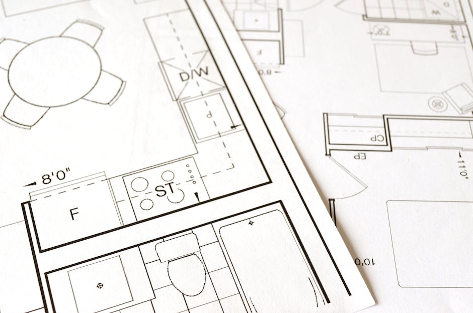 Close-up view of an architectural floor plan on paper showcasing detailed room layouts and measurements