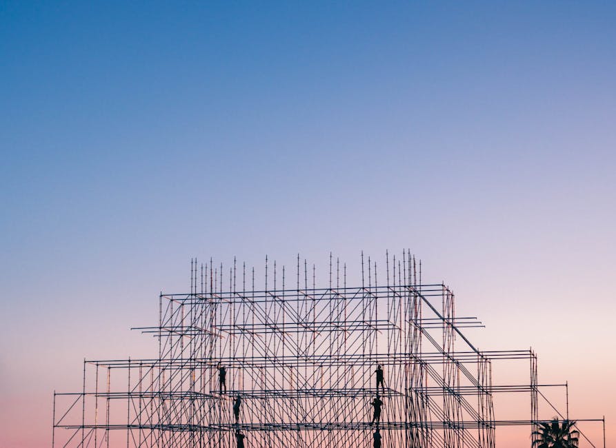 A silhouetted structure against a colorful sunset, showcasing industrial scaffolding in Sochi, Russia