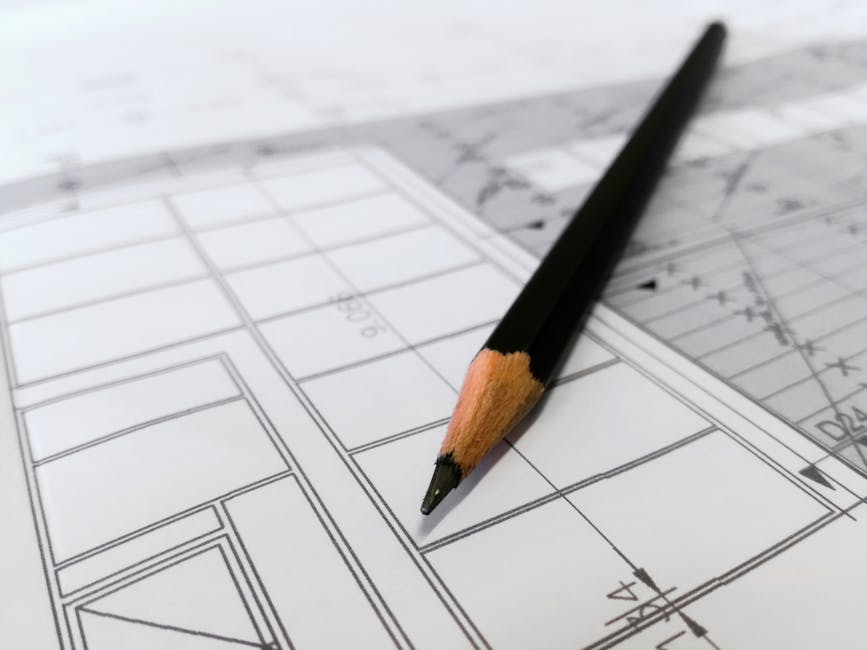Detailed image of a black pencil resting on architectural blueprints, ideal for design and planning themes