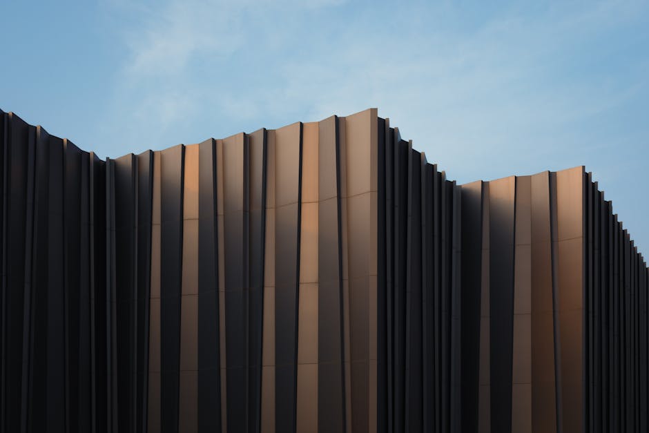 Sleek modern building facade with unique design set against a clear blue sky